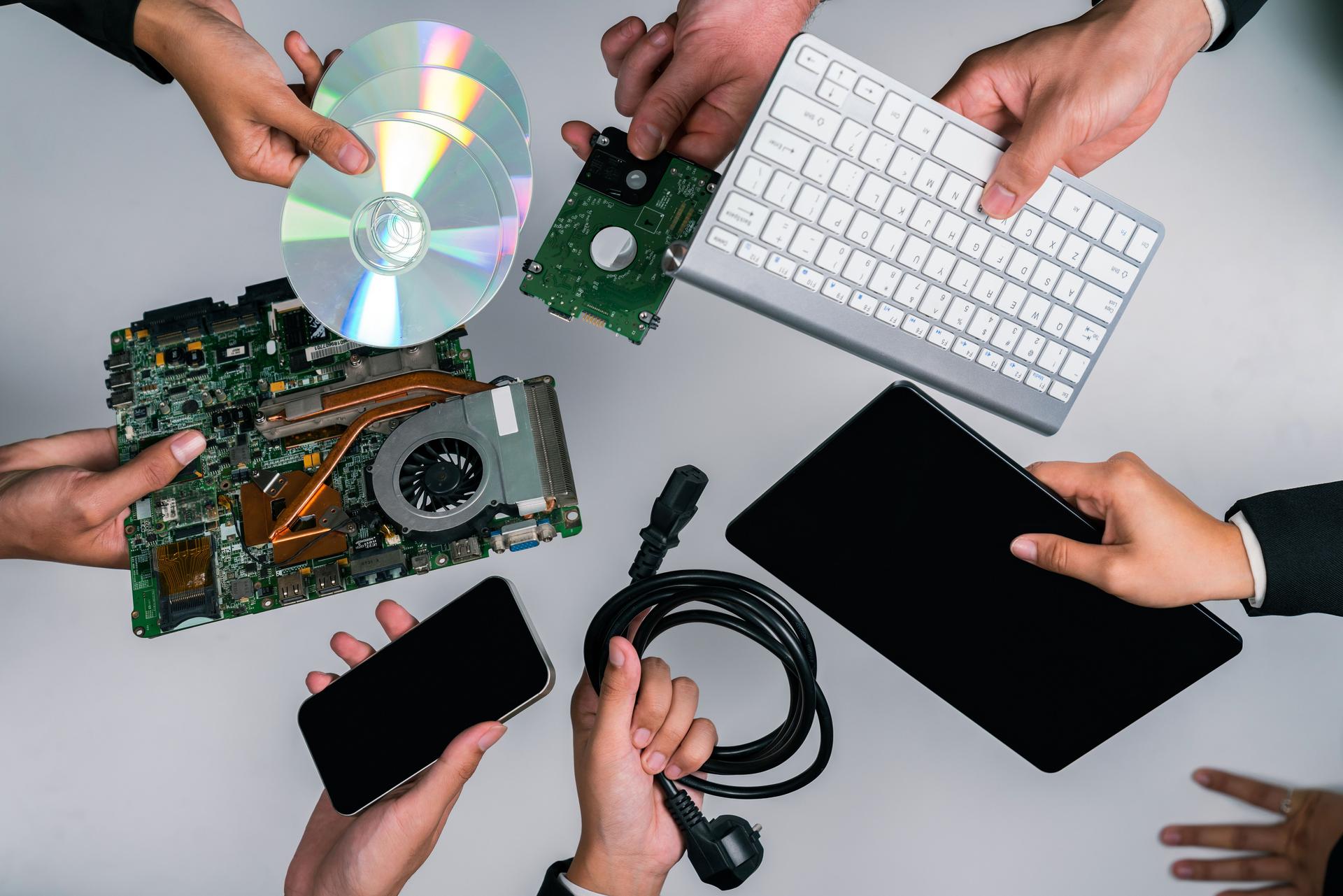 Businessman's hand holding electronic waste on isolated background. Quaint